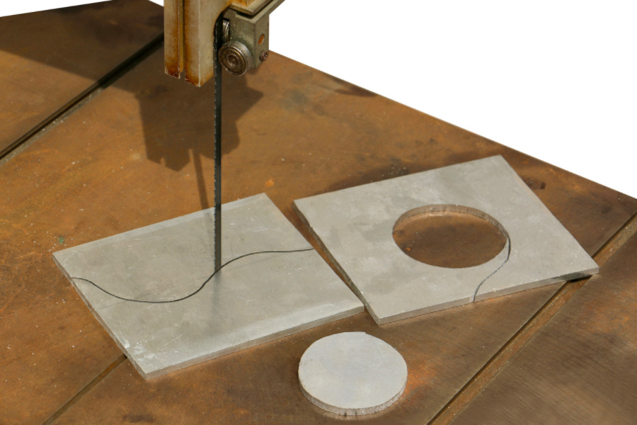Industrial band saw cutting intricate curves and contours on a workpiece