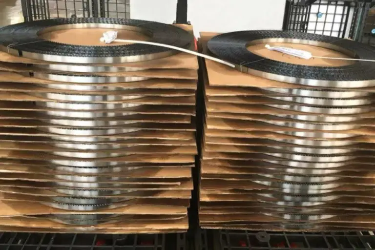 Two neat stacks of manufactured band saw blades ready for packaging