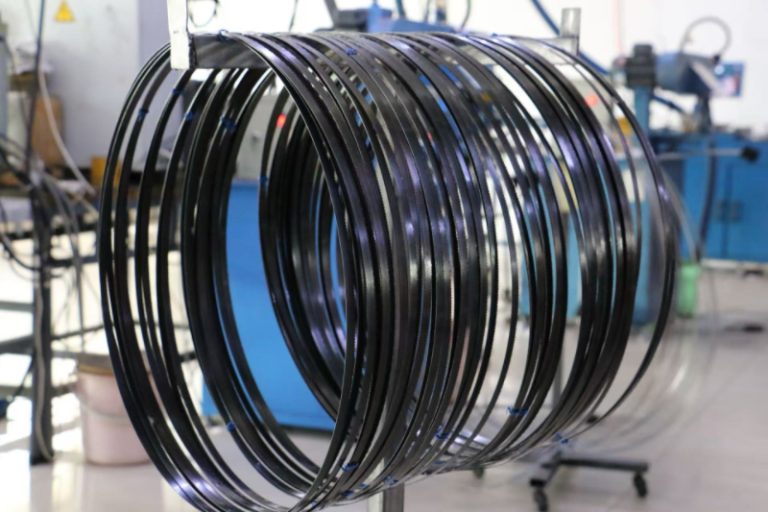 Multiple welded carbon steel band saw blades hanging after quality inspection